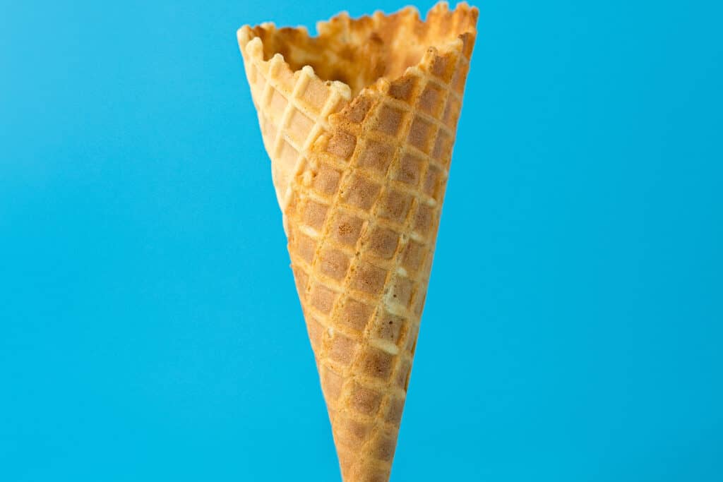 empty waffle cone on blue background